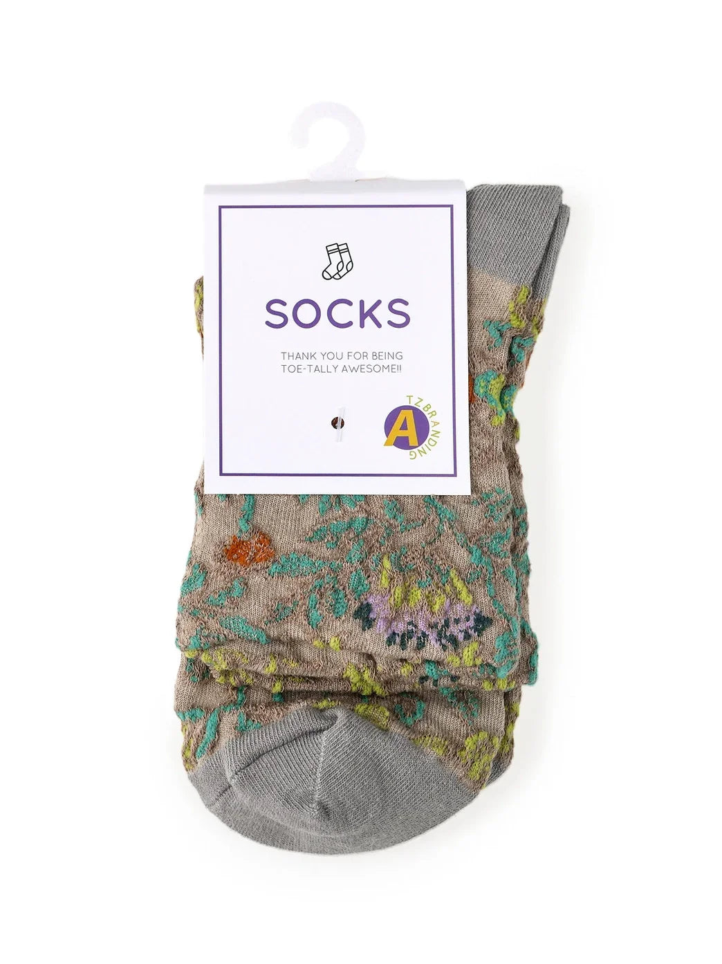 Gray socks with colorful floral pattern, packaging labeled 'Socks' and music note graphic.
