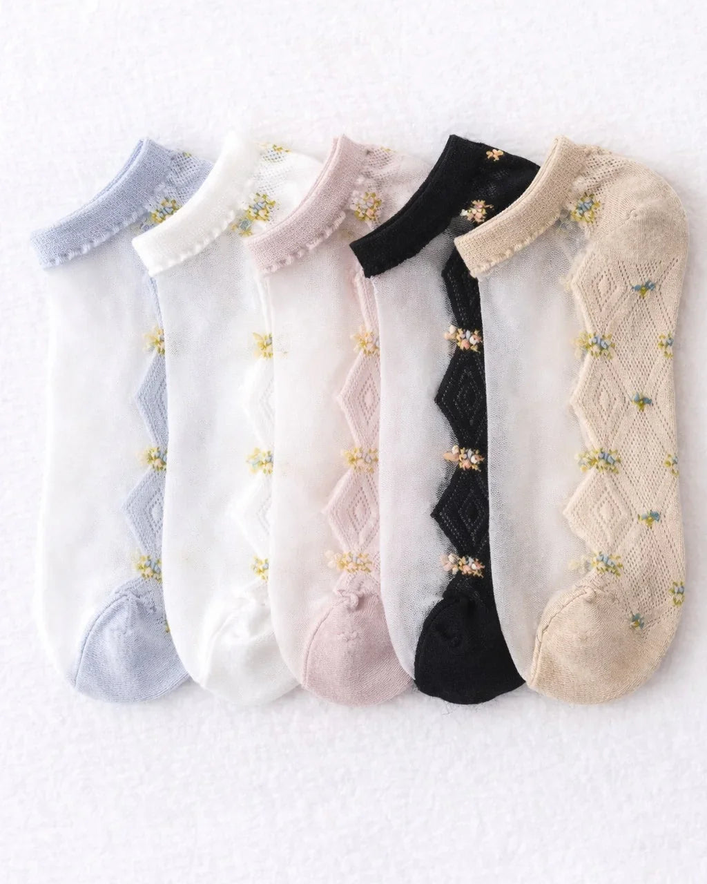 Pack of five low rise socks in pastel and neutral colors with braided floral patterns