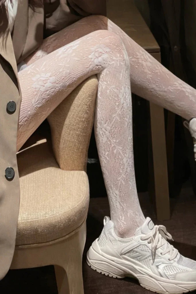 Close-up of cream floral lace tights with semi-sheer texture and delicate pattern