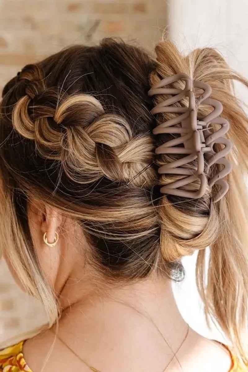 Woman with braided hair styled in a bun using a large hair claw clip, Love Classic