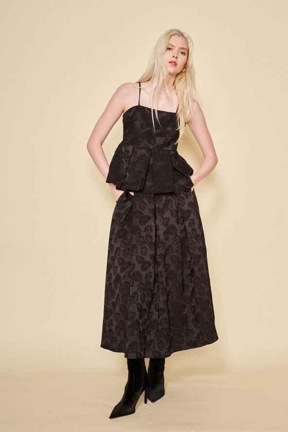 Woman wearing a black floral jacquard top and skirt set from Love Classic, fashion photography