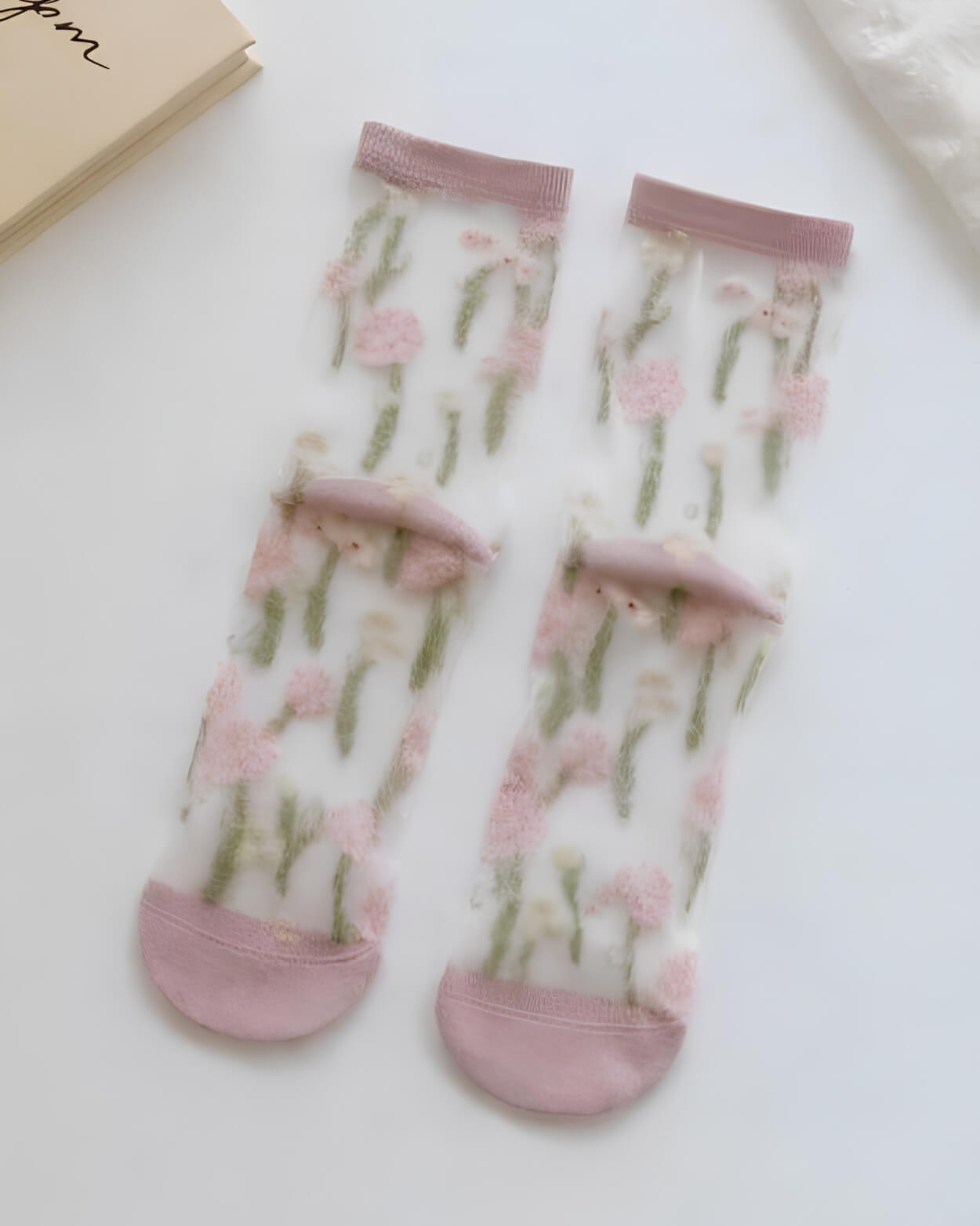 Floral Pattern Sheer Socks 4-Pack featuring soft pink floral prints with green stem accents on transparent mesh fabric, finished with blush cuffs and reinforced toes, highlighting lightweight comfort and romantic everyday style.