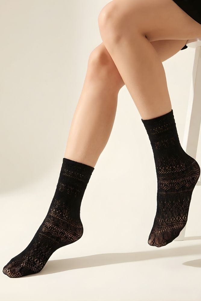 Lace Pattern Sheer Sock featuring sheer black lace pattern socks worn on lifted legs against a soft background, emphasizing stretch fit, lightweight feel, and intricate knit detailing.
