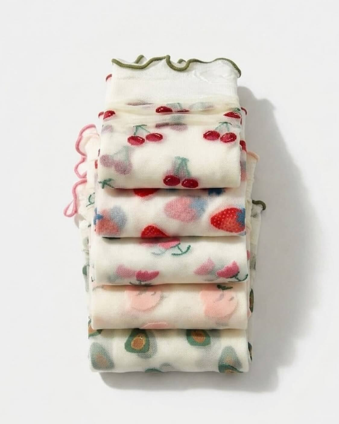 Whimsical Ruffle Edge Sheer Socks bundled collection featuring mixed fruit and floral embroidery with soft transparent fabric and delicate ruffle edge cuffs, stacked neatly on a minimal white background to highlight the assorted playful patterns.
