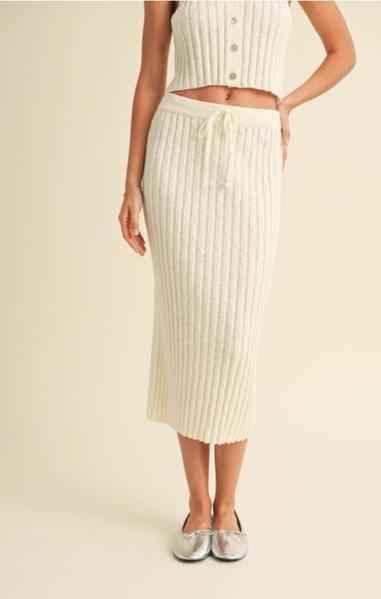 Woman modeling a ribbed cream knit skirt and matching crop top from Love Classic