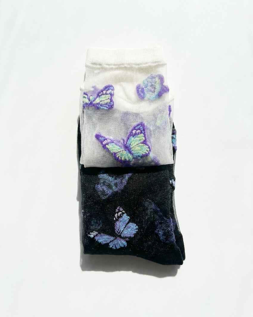 Butterfly Dreams Sheer Socks Bundle Pack featuring folded white and black sheer socks with embroidered butterfly motifs, stacked together on a clean studio background, highlighting the bundle pack presentation and lightweight translucent finish.
