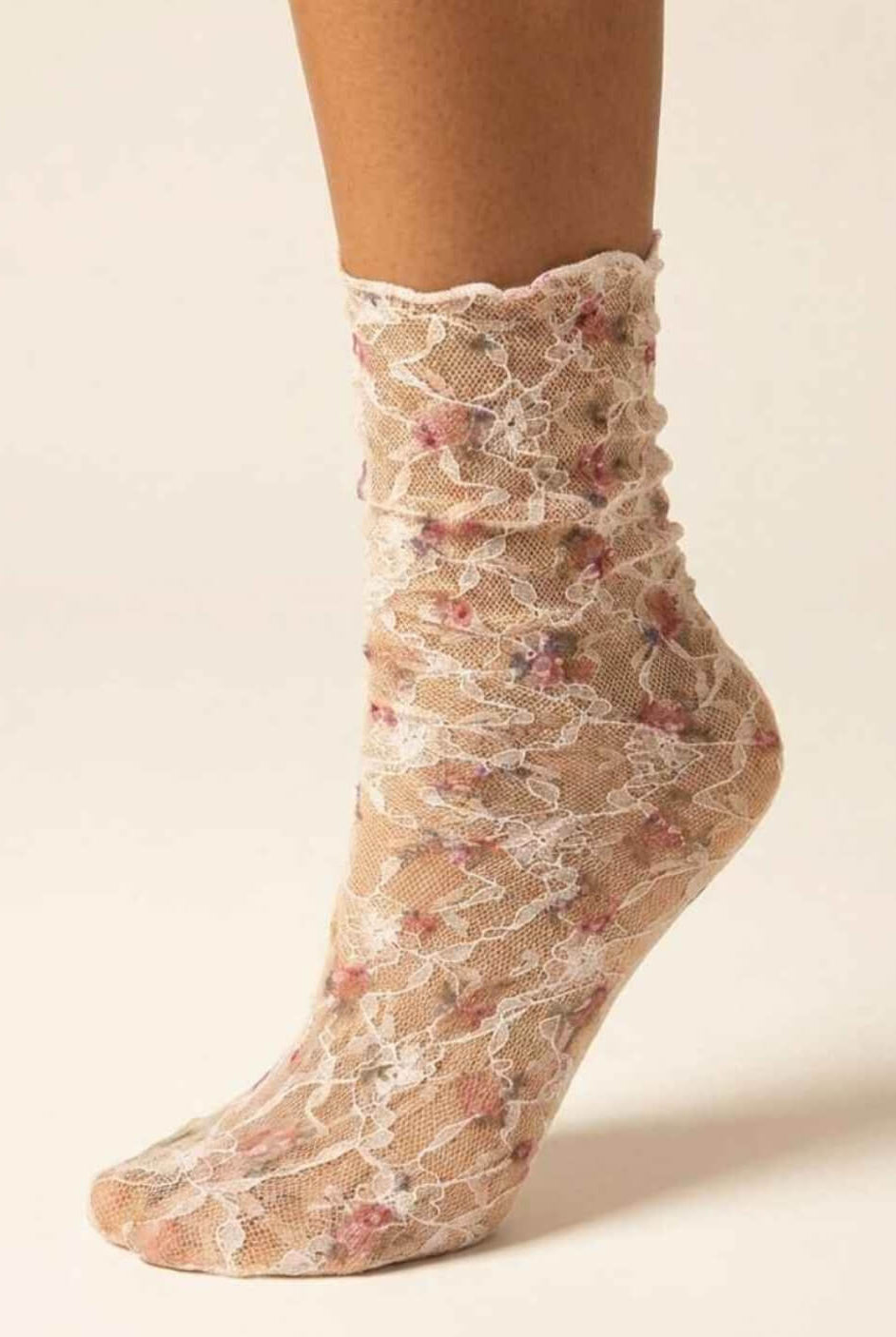 Floral Mesh Sheer Socks in pink floral lace mesh, shown on one foot with ruffled crew cuff and white lace detailing.