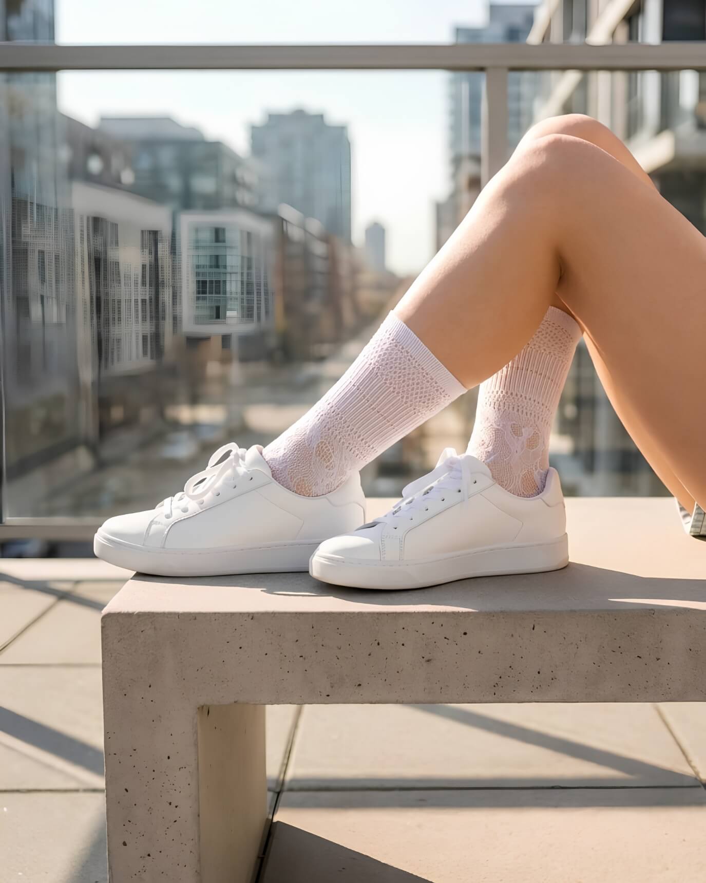 Sheer Floral Lace Crew Socks in white featuring a detailed floral lace design, styled with white sneakers on an outdoor balcony, showcasing the versatile, semi-transparent fabric and casual everyday styling.