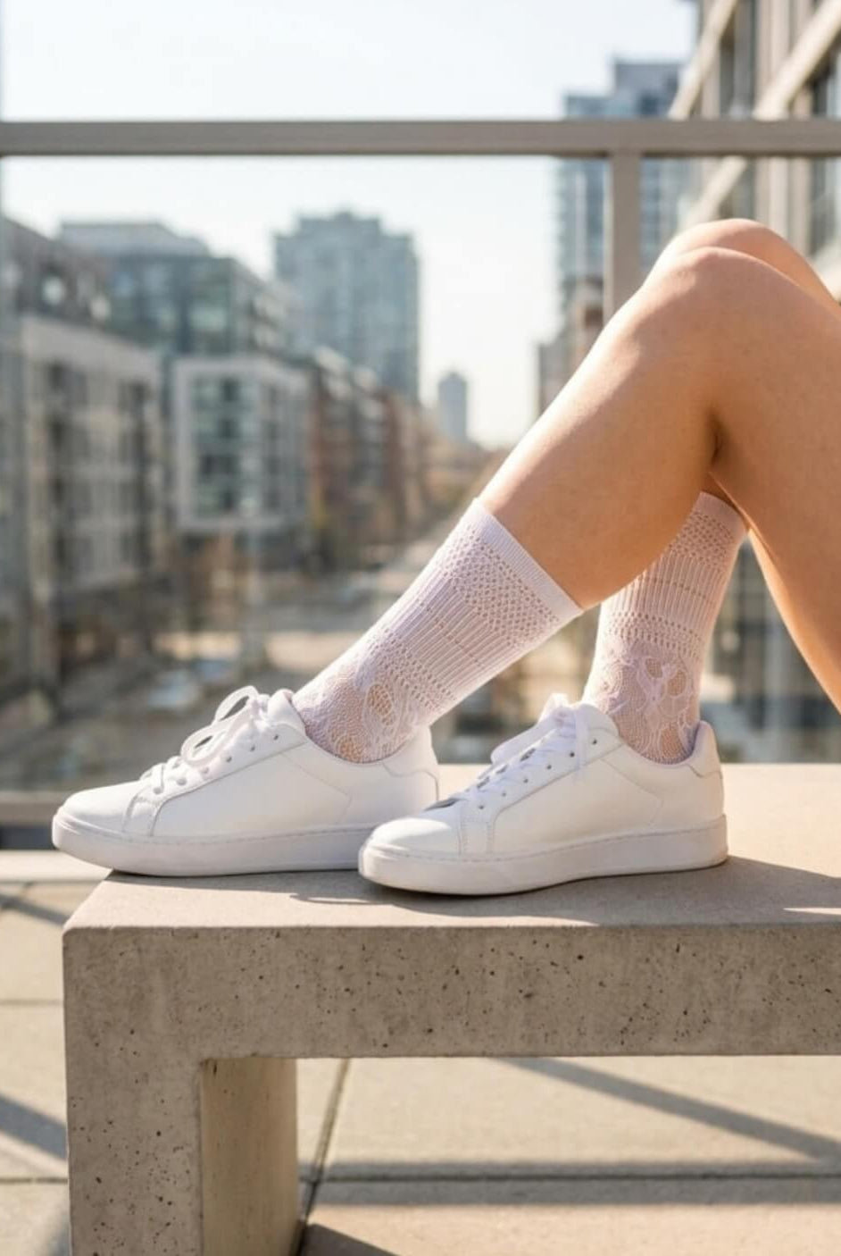 Sheer Floral Lace Crew Socks in white featuring a detailed floral lace design, styled with white sneakers on an outdoor balcony, showcasing the versatile, semi-transparent fabric and casual everyday styling.