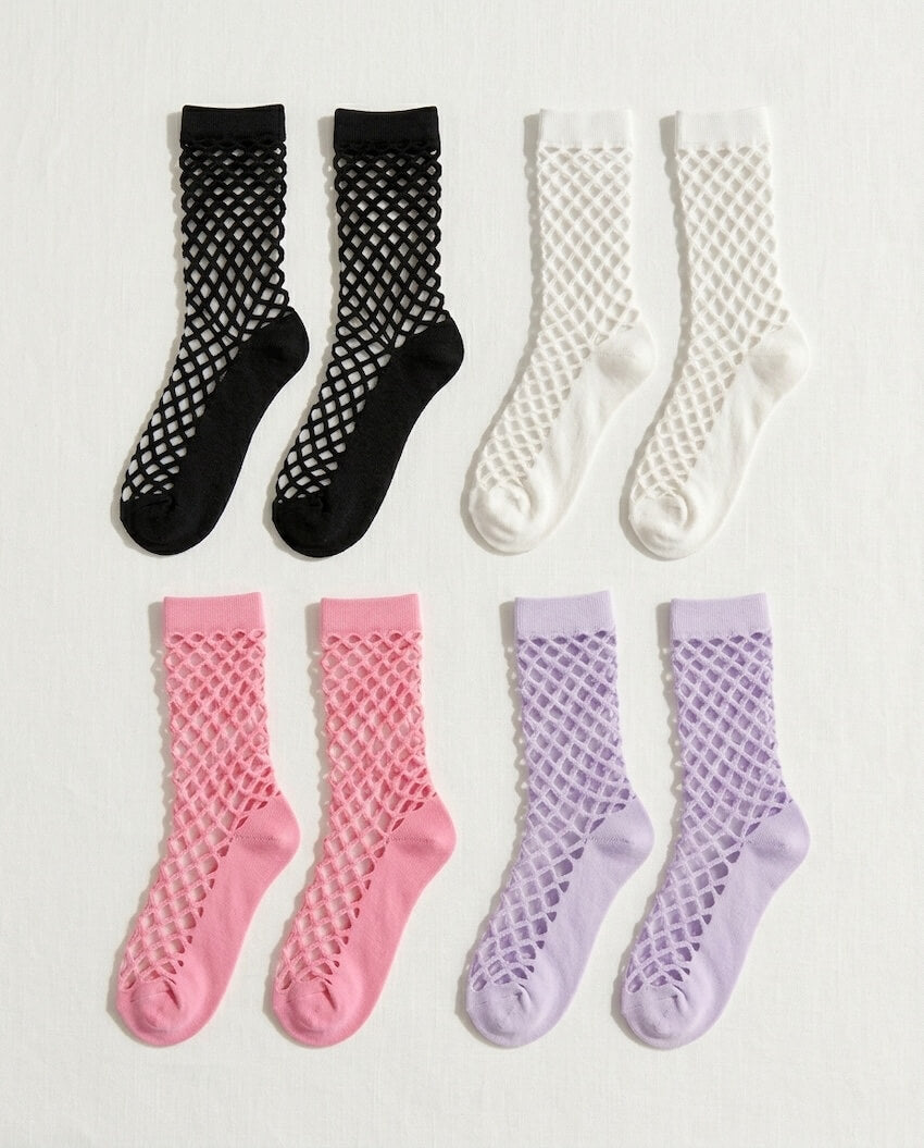 Midnight Lattice Fishnet Socks featuring a bold fishnet lattice knit with stretchy breathable construction and assorted solid color variations, displayed in black, white, pink, and lavender tones on a clean background to highlight the versatile multi-color styling options.