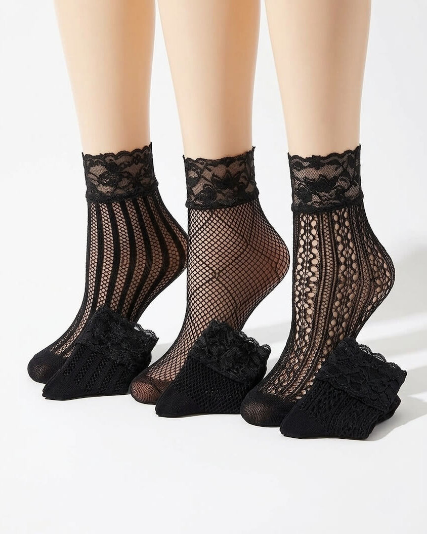 3-Pack Floral Diamond Lace Fishnet Socks featuring three unique black fishnet patterns with floral lace cuffs, displayed together on mannequin legs in a studio setting, highlighting the variety of openwork textures, elegant lace detailing, and versatile styling options for dresses, skirts, and casual footwear.