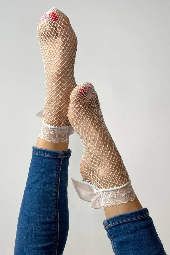 White fishnet lace socks with ribbon bows styled with jeans, Love Classic fashion accessories