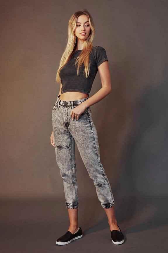 Woman in black crop top and acid-wash jeans, casual fashion by Love Classic