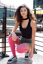 Woman wearing pink thigh high socks.