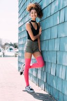 Woman wearing pink thigh high socks. 2