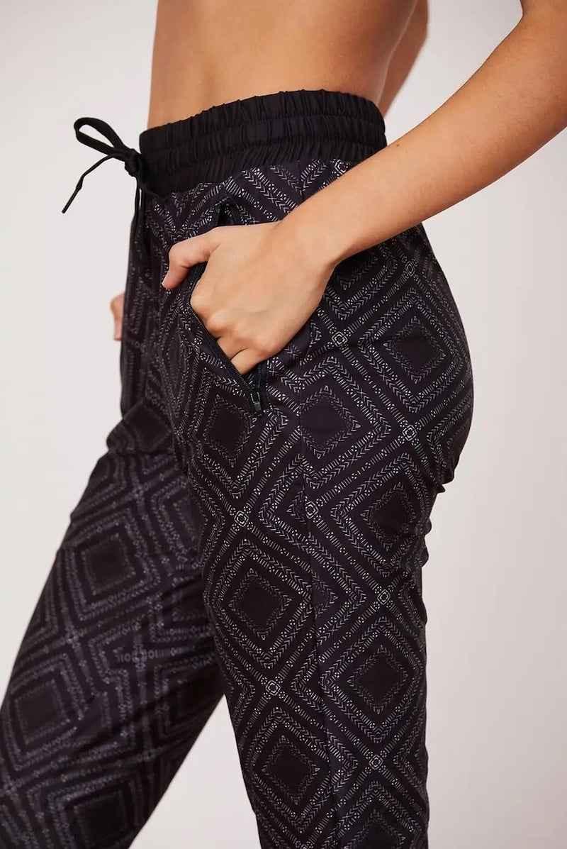 Close-up of black geometric jogger pants with drawstring waist from Love Classic