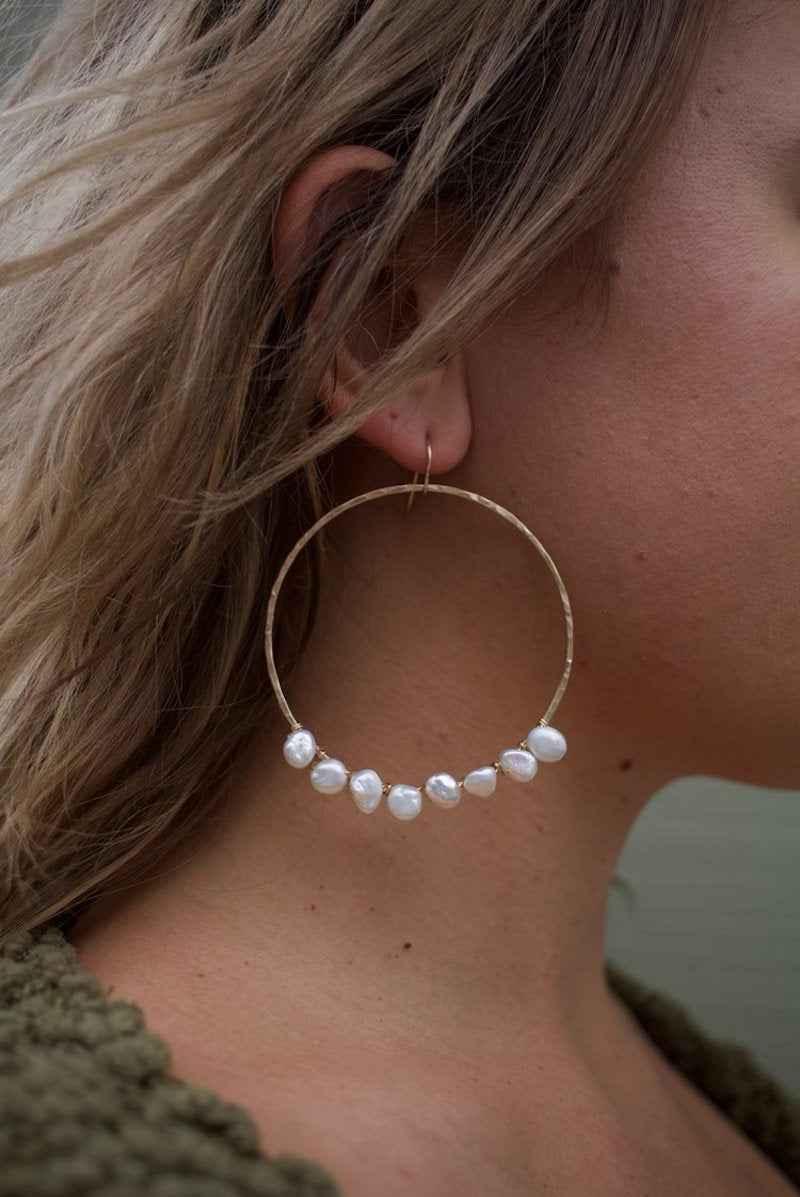 Gold hoop earring with white pearls worn by woman, Love Classic high quality jewelry