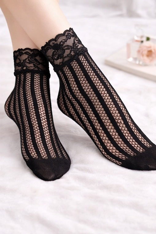 Black floral lace vertical stripe fishnet ankle socks worn with lace cuff detail, styled on feet against a soft neutral background.