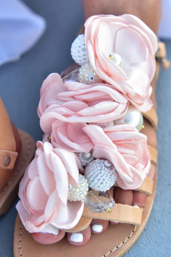 Tan sandal with large pink fabric flowers and beaded accents from Love Classic