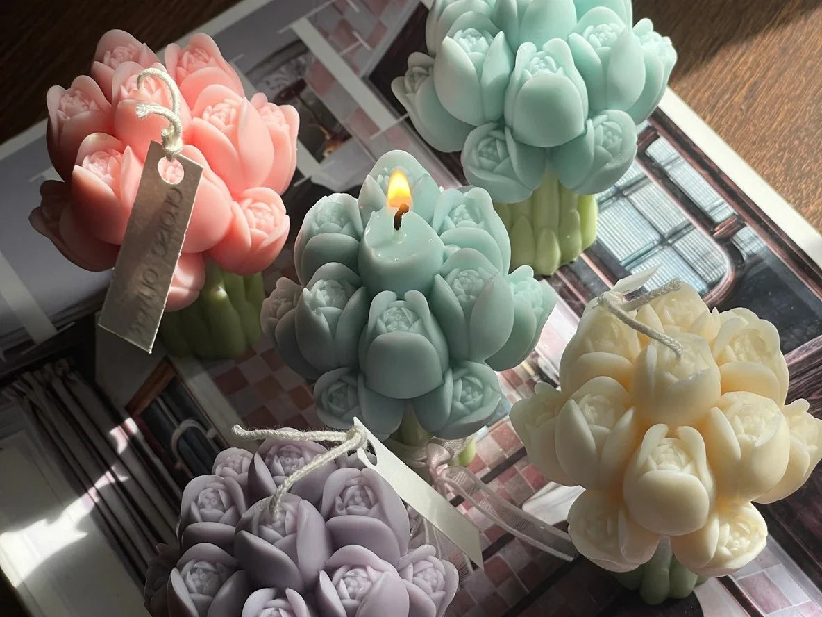 Assorted flower-shaped decorative candles in pastel colors on a wooden surface, Love Classic style