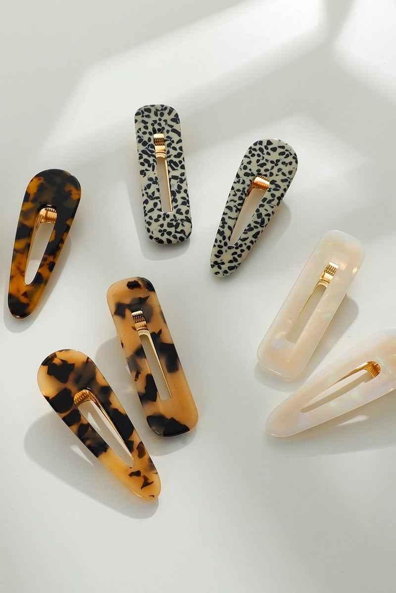 Assorted acrylic hair clips in tortoiseshell, animal print, and beige by Love Classic