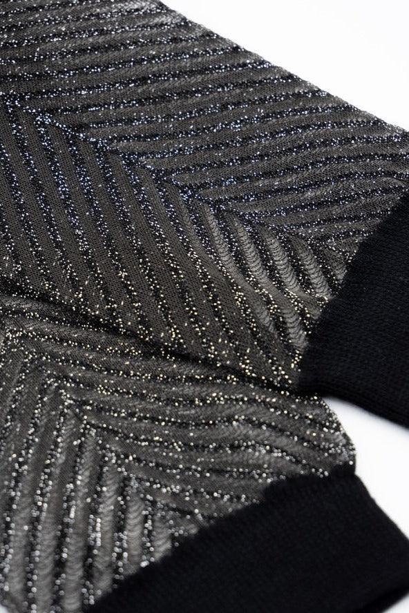 Close-up of sparkly black and silver knit fabric sleeves from Love Classic high quality styles