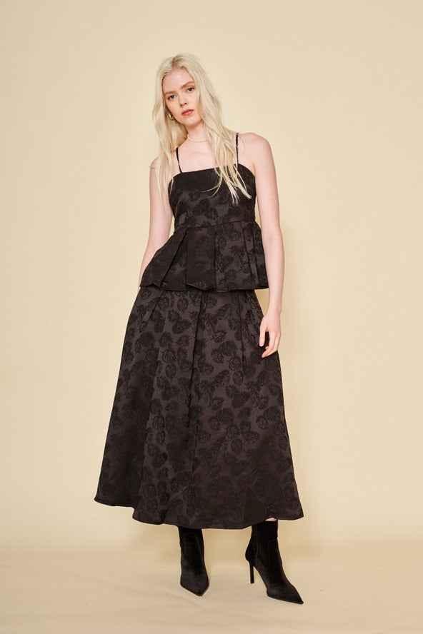 Woman wearing a black jacquard top and skirt set with boots, Love Classic fashion style