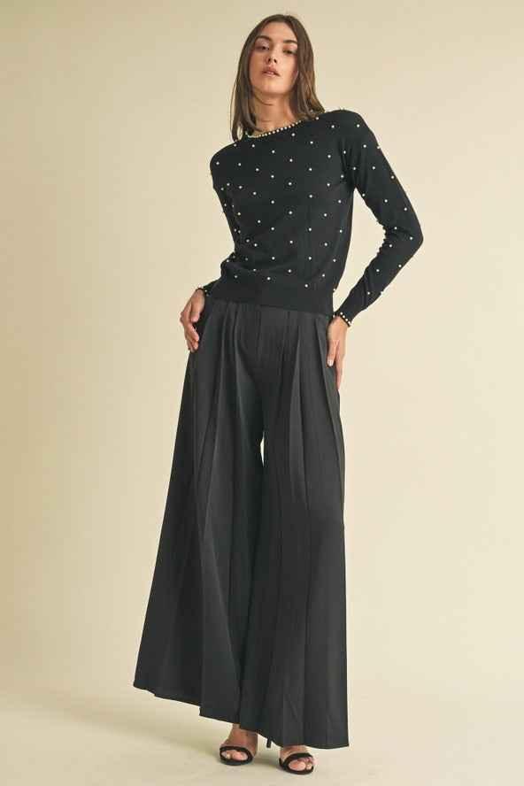 Woman in black pearl-detailed sweater and wide-leg pants, Love Classic high quality fashion