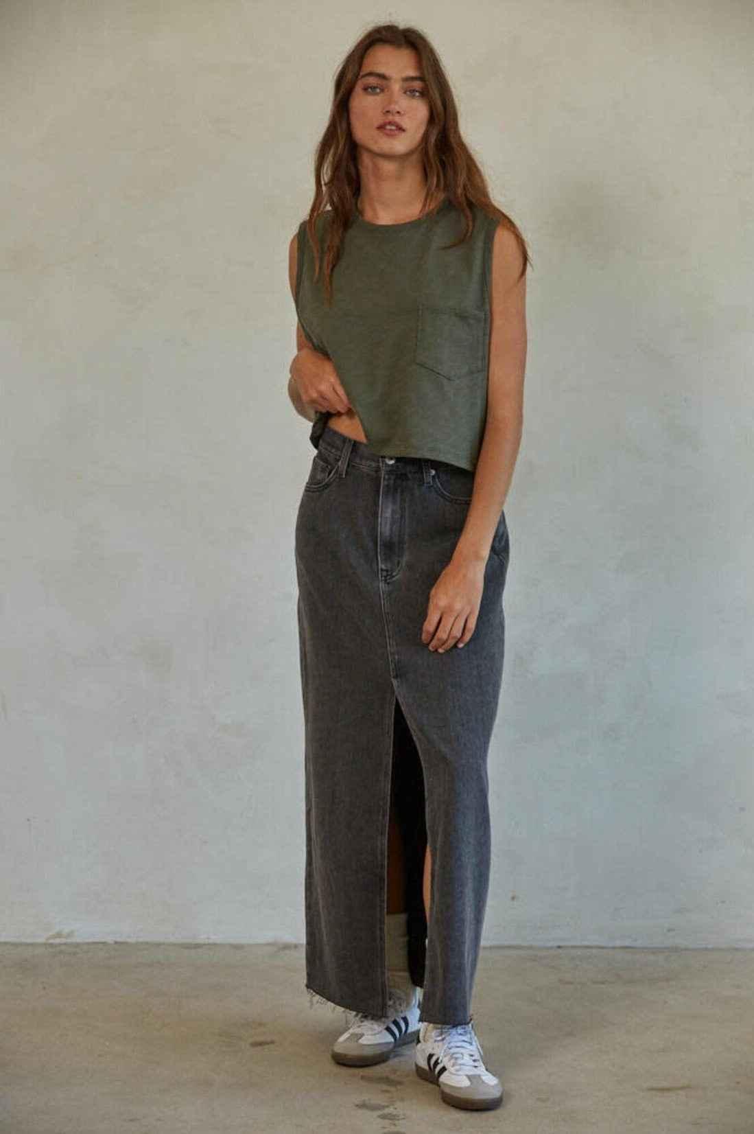 Woman wearing olive green pocket tank top, long black denim skirt, and sneakers, Love Classic