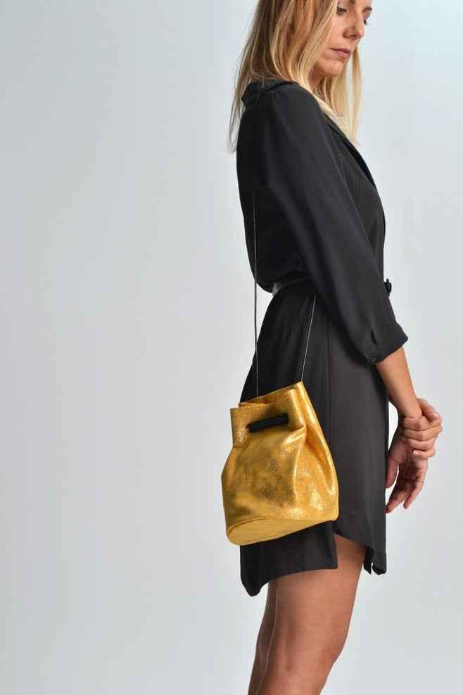 Woman in black dress with gold metallic handbag, Love Classic high quality style