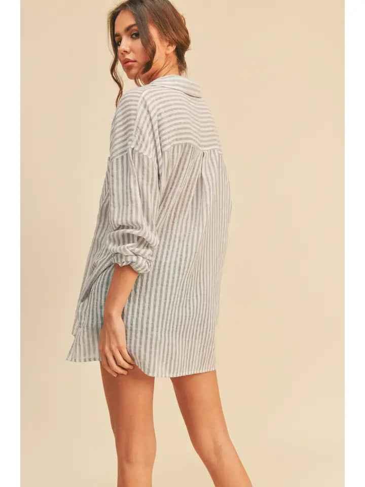 Woman modeling oversized striped shirt dress from Love Classic, neutral background