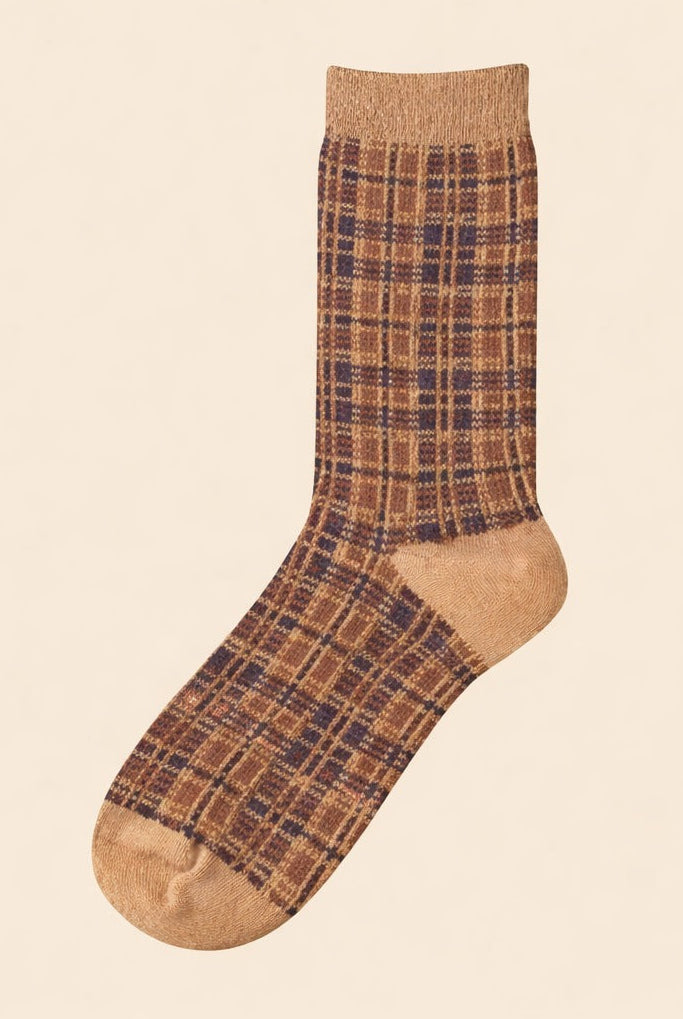 Neutral brown plaid ribbed crew sock with solid heel and toe, photographed on a beige background.