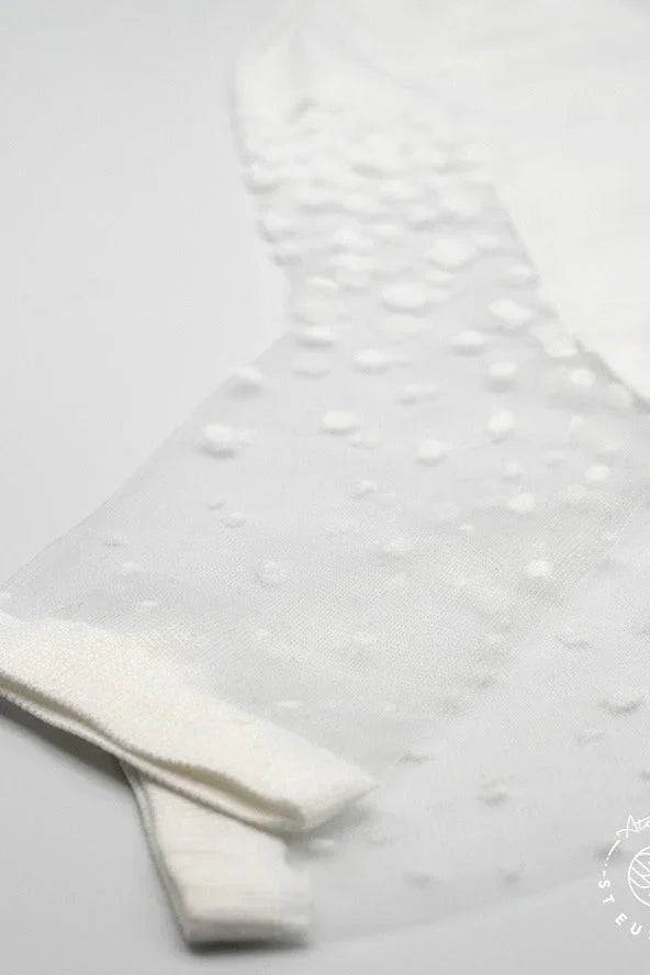 White sheer textured mesh fabric with subtle polka dot pattern, delicate and elegant style