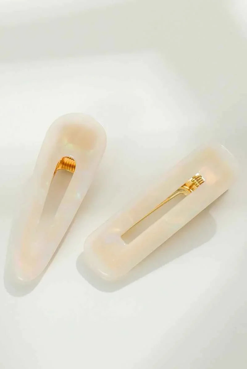 Love Classic pearl acrylic hair clips with gold clasp on white background