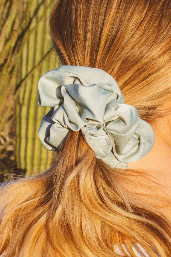 Close-up of the Eucalyptus Jumbo Scrunchie showcasing the smooth sateen fabric, matte finish, and light blue green eucalyptus color.