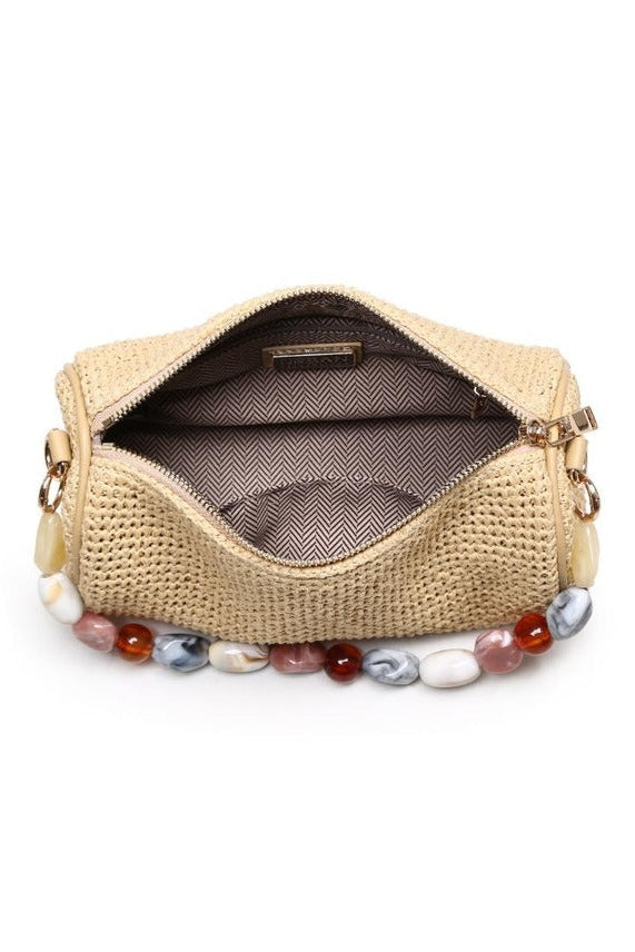 Interior view of the natural Rachel Straw Clutch displaying a neatly sized compartment that fits a phone, cards, and daily must-haves.