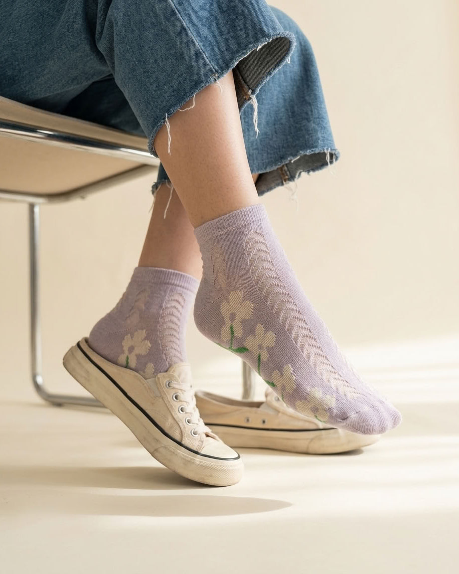 Lavender daisy pointelle low-cut socks worn with white canvas sneakers