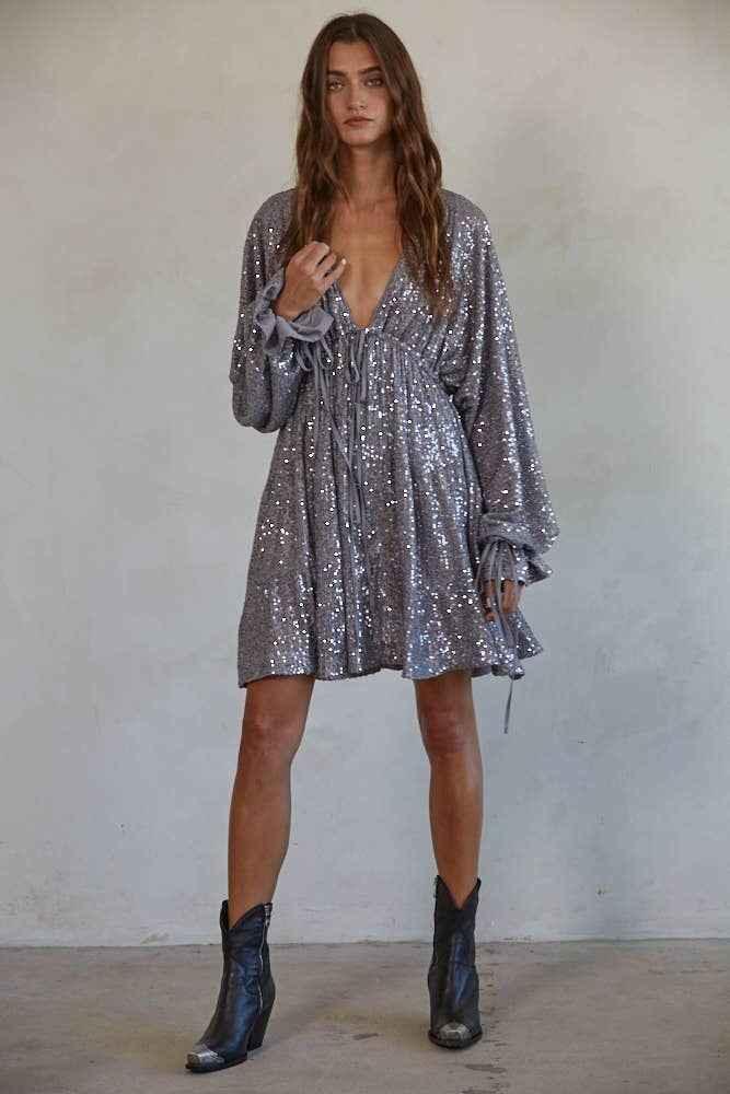 Woman in silver sequin mini dress with long sleeves and boots, Love Classic fashion style