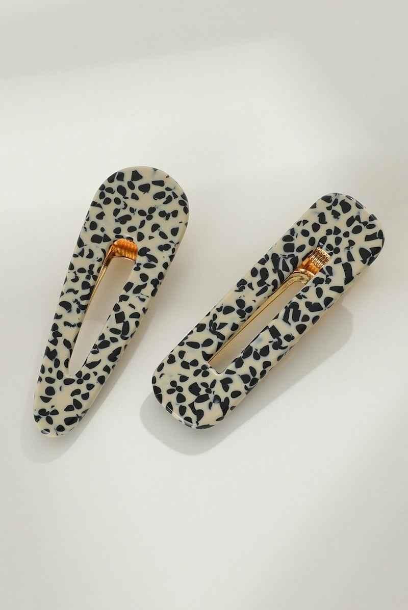 Love Classic black and white spotted hair clips with gold accents on a white background