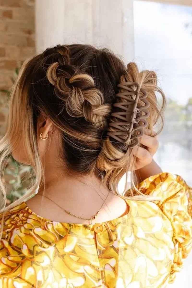 Woman with braided hair in a claw clip, wearing yellow floral blouse, Love Classic style