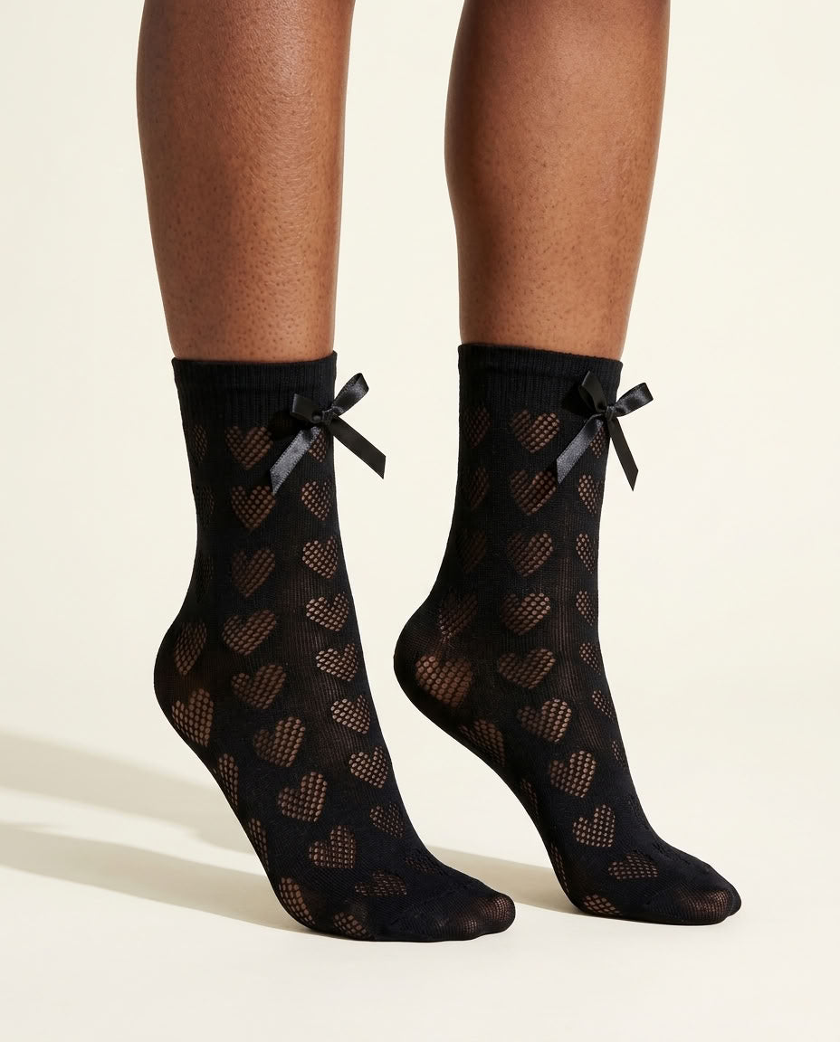 Black Heart-Shaped Lace Bow Socks, close-up on tiptoe showing open-knit hearts and satin bows