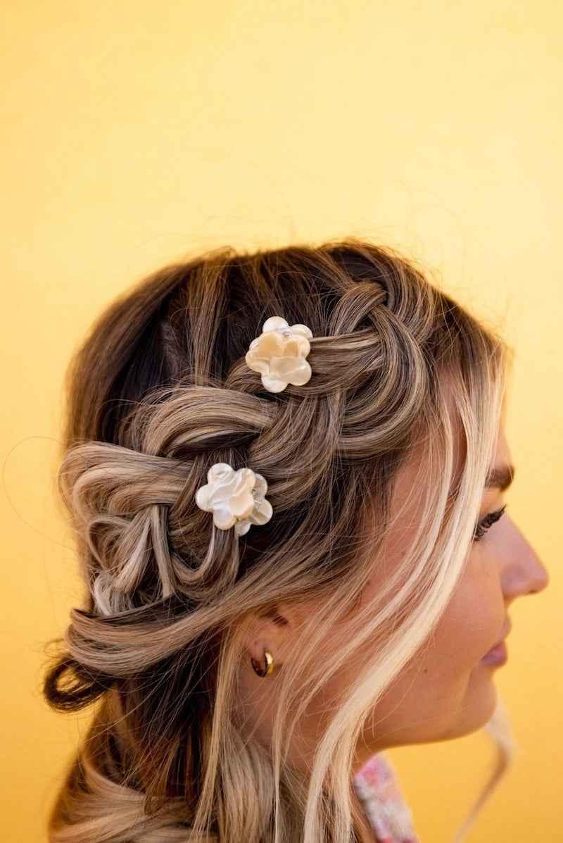 Woman with braided blonde hair adorned with white flower clips, Love Classic style