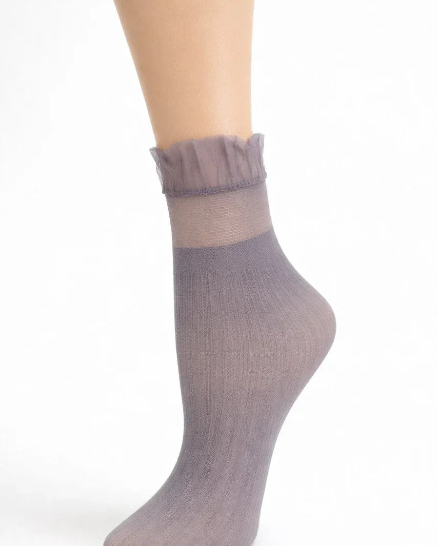 Medium gray sheer ankle sock with ruffled top on a model foot, white background