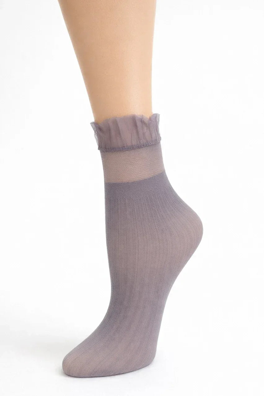 Medium gray sheer ankle sock with ruffled top on a model foot, white background