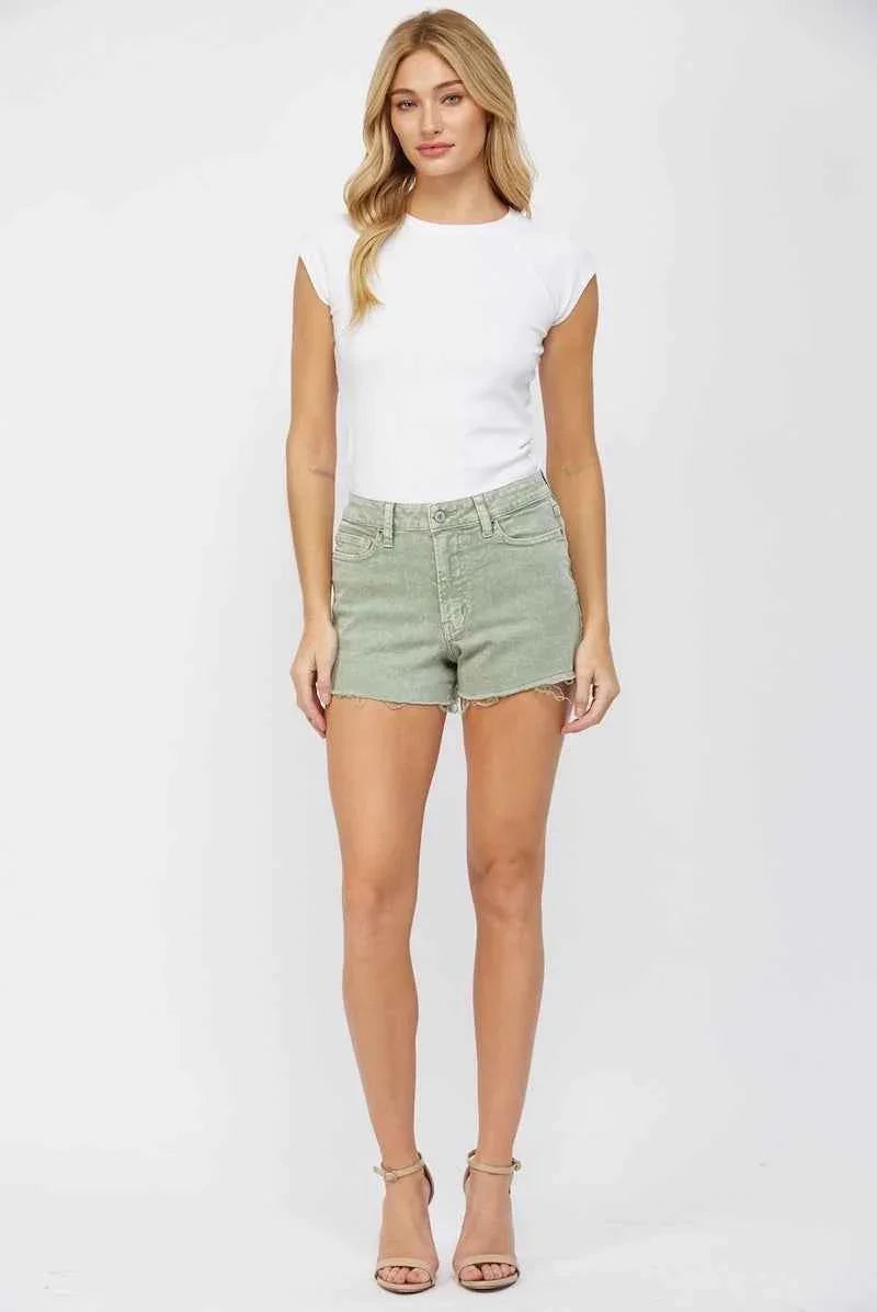 Woman wearing high-waisted green denim shorts and white top, Love Classic casual fashion