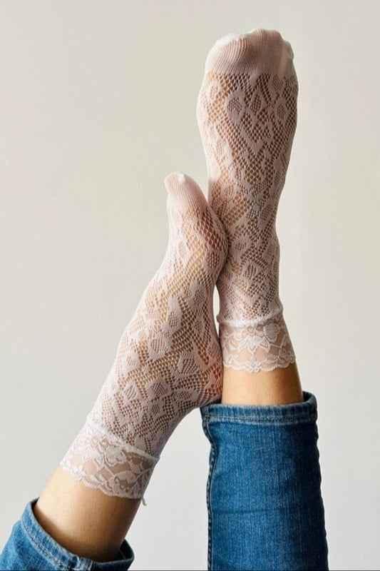 Light pink lace socks from Love Classic paired with blue jeans, showcasing stylish hosiery