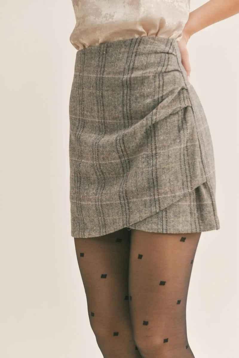 Plaid wrap mini skirt from Love Classic with sheer polka dot tights, neutral background