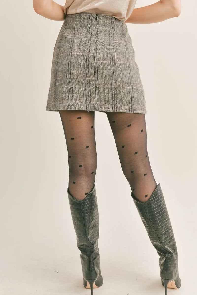 Plaid mini skirt with black polka dot tights and knee-high boots from Love Classic