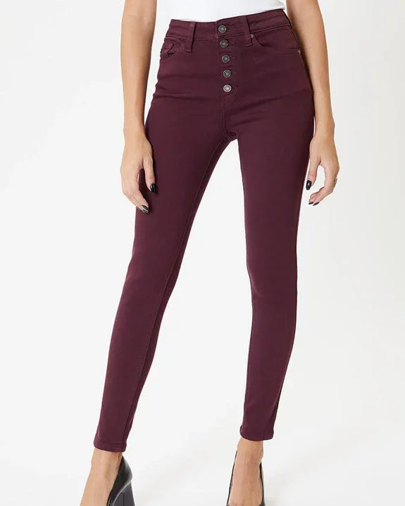 Woman wearing high-waisted burgundy skinny jeans from Love Classic with black heels