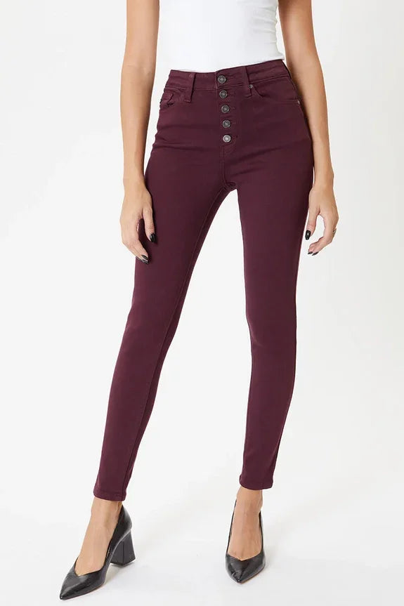 Woman wearing high-waisted burgundy skinny jeans from Love Classic with black heels
